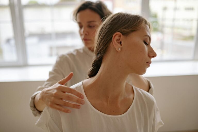 Two women engaged in a calming massage session, promoting wellness and relaxation.
